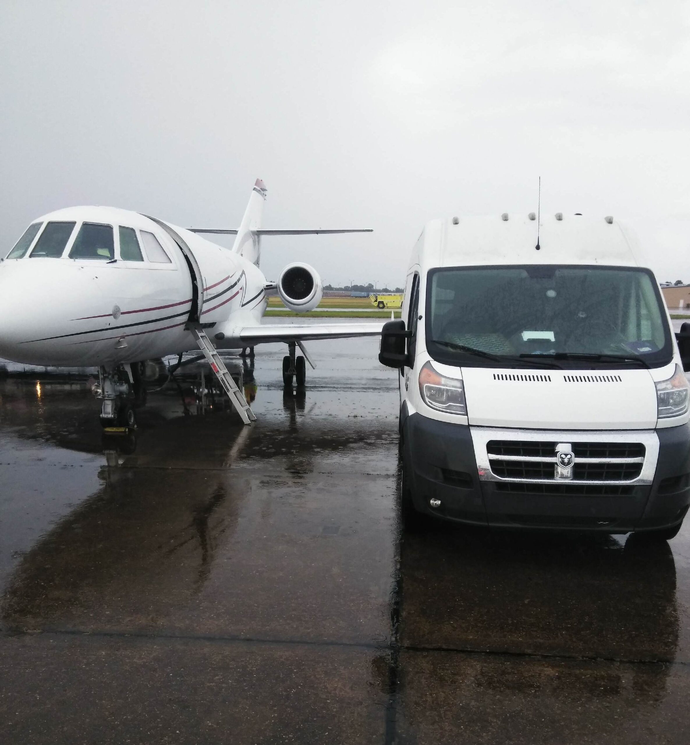 The Backbone of Door to Door Air Charter: Ground Transportation. a plane and van on a tarmac.